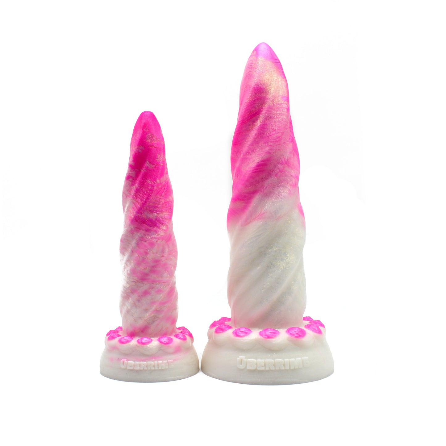 Two unicorn horn-shaped dildos with a flared base, featuring a pearl pink and pearl white ombre with gold pigment.