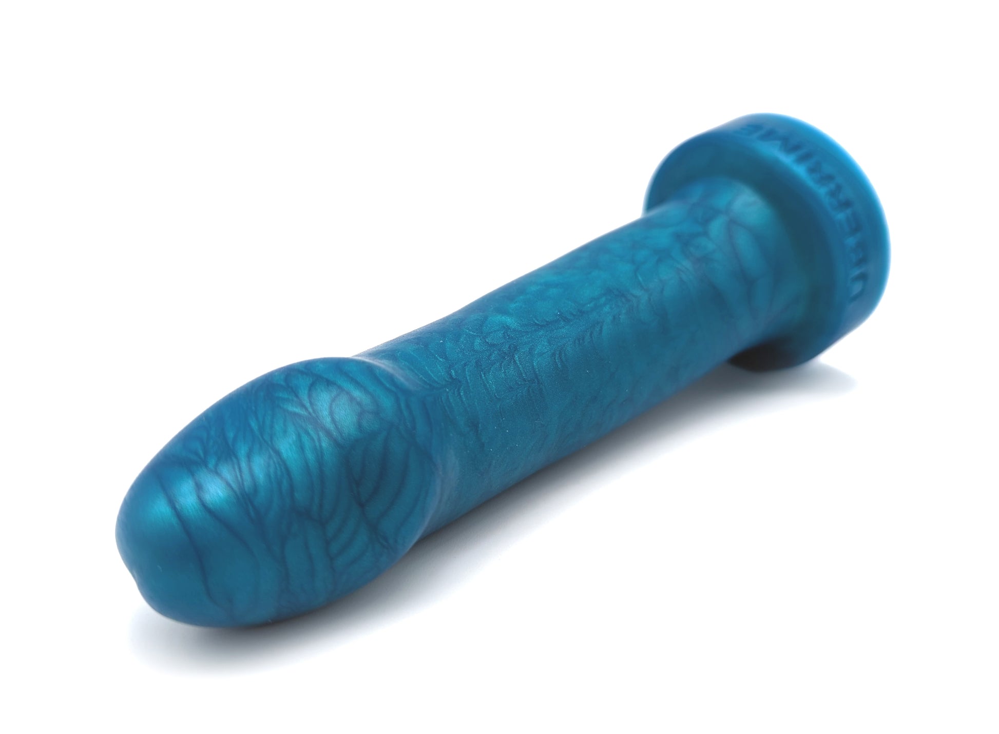 A beginner-friendly silicone dildo laying on its side. There’s a swirly effect to the silicone pigmentation. The toy’s flared base is round. 